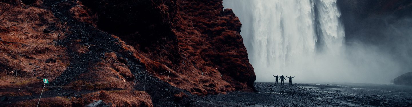 people on the background of the waterfall